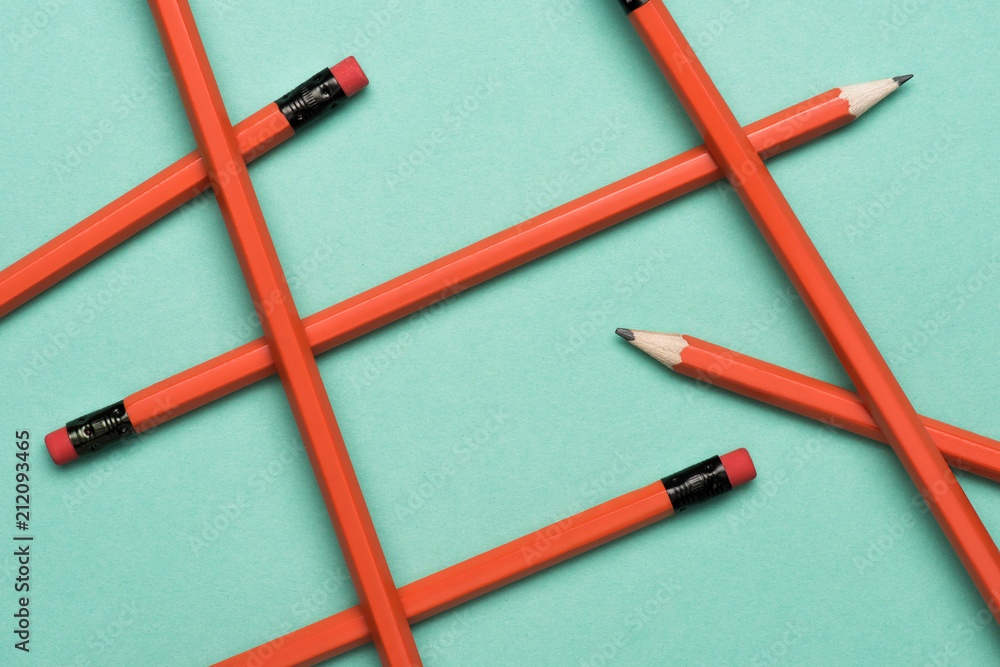 top view of arranged graphite pencils with erasers on green top view of arranged graphite pencils with erasers on green