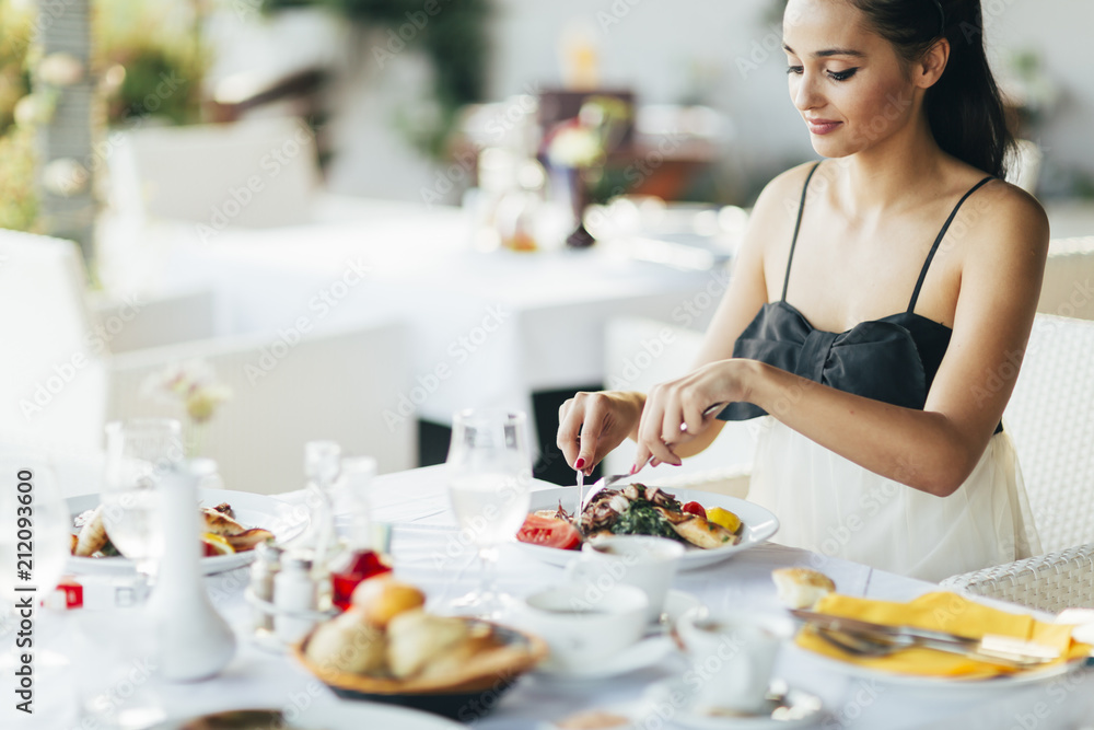 Beautiful woman eating meal in restaurant Beautiful woman eating meal in restaurant