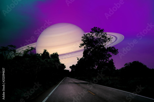 Fototapeta Naklejka Na Ścianę i Meble -  Saturn near earth on night sky over the country road