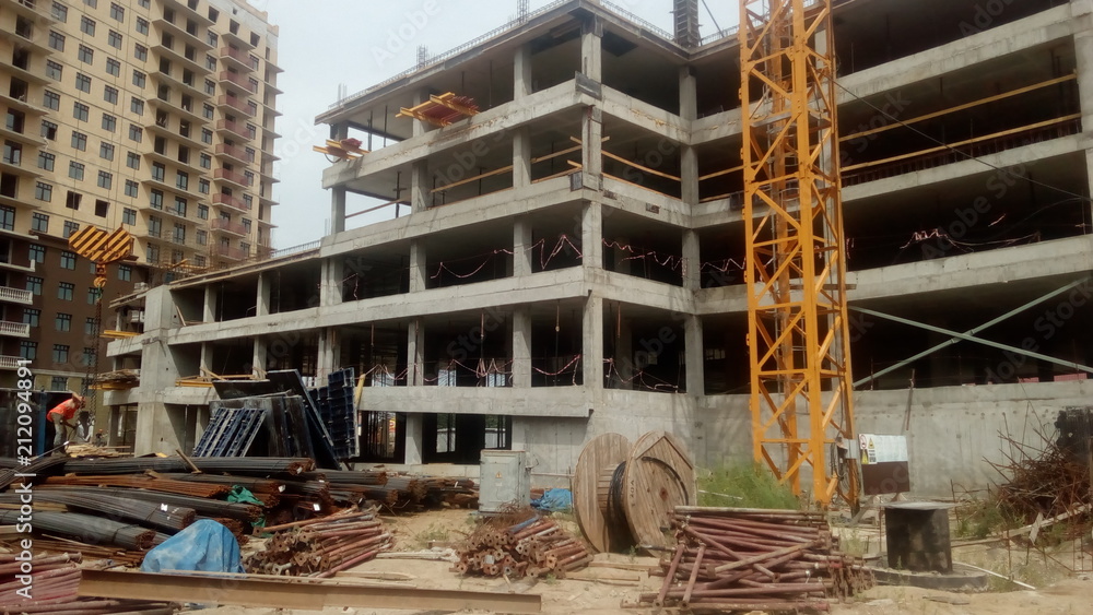 Naklejka premium Construction of a multi-apartment residential building. The process of construction. Stages of construction.