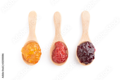 Strawberry, orange and blueberries jam with wooden spoon on a white background. top view.