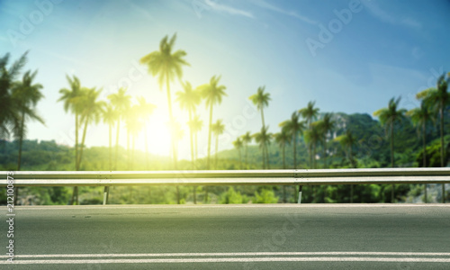 Summer background of road with palms and sunset time  © magdal3na