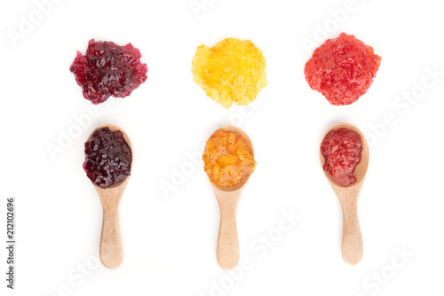 Strawberry, orange and blueberries jam with wooden spoon on a white background.