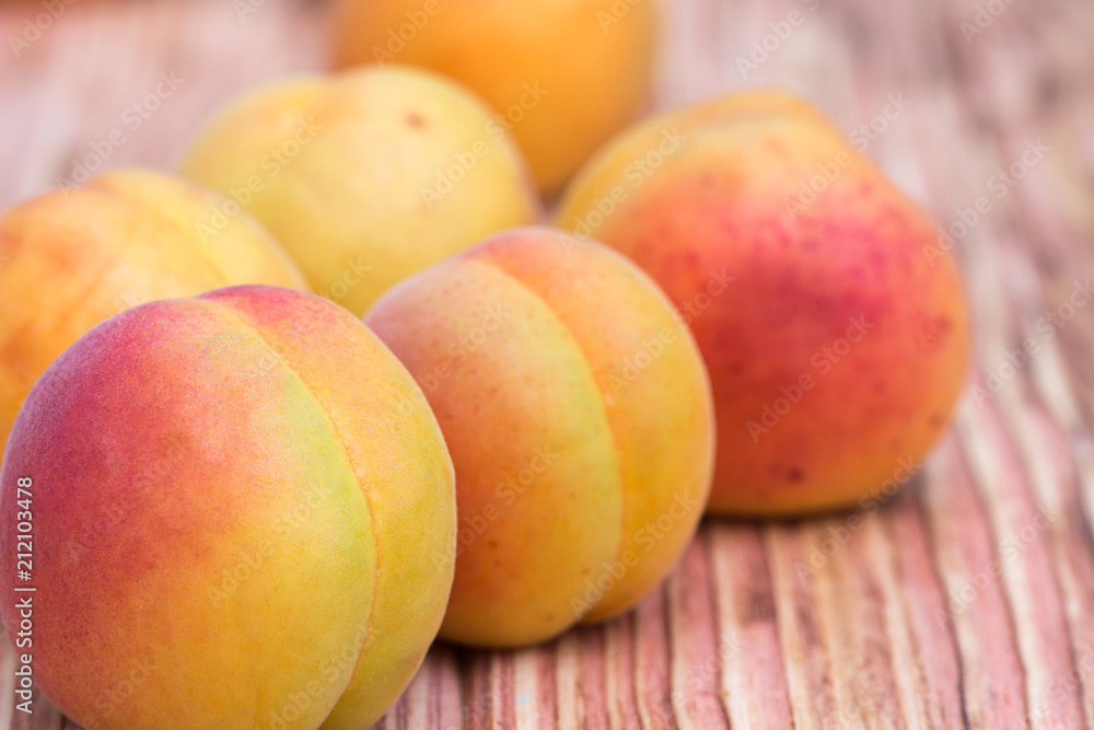 Close-up ripe apricots on wood background Close-up ripe apricots on wood background