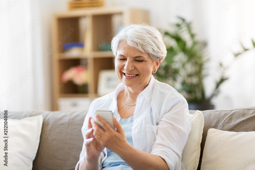 technology, communication and people concept - happy senior woman with smartphone at home technology, communication and people concept - happy senior woman with smartphone at home