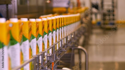 Plant juice. Juice packaging are moving on the conveyor belt