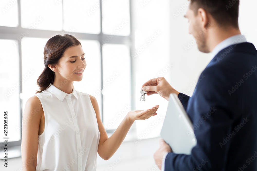 real estate business, sale and people concept - realtor giving key to customer or new office owner real estate business, sale and people concept - realtor giving key to customer or new office owner