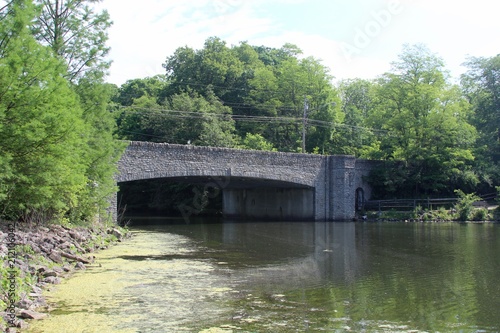 The old stone bridge over the lake in the park.