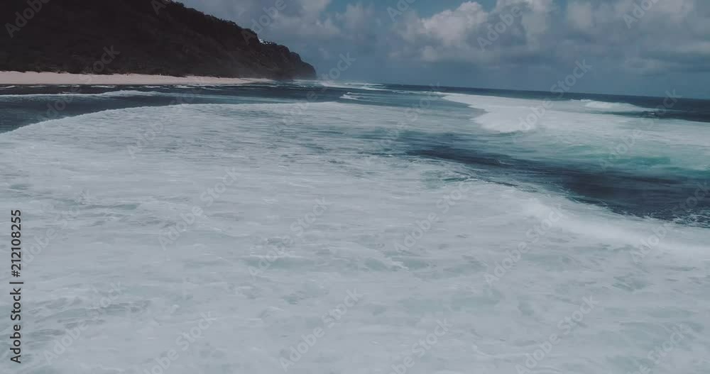 Aerial drone view of beautiful ocean waves with white water foam against cloudy sky - video in slow motion Aerial drone view of beautiful ocean waves with white water foam against cloudy sky - video in slow motion