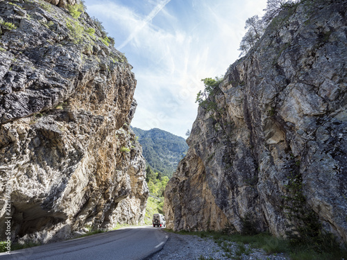 car on road between high rocks in mountains of french parc regional du queyras of haute provence