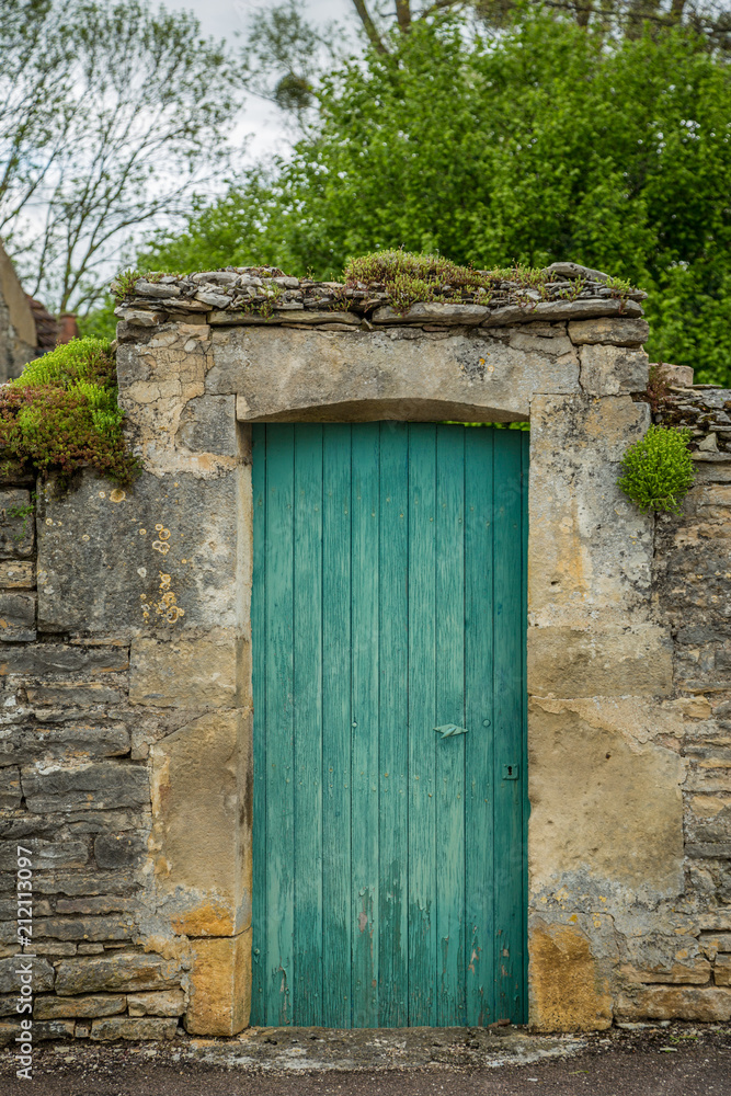 Green door in the picturesque town of Noyers sur Serein, Burgundy, France