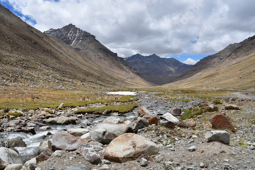 China, Tibet. Mountain river near the trail of parikrama around Kailas after the descent from the pass of Drolma La photo