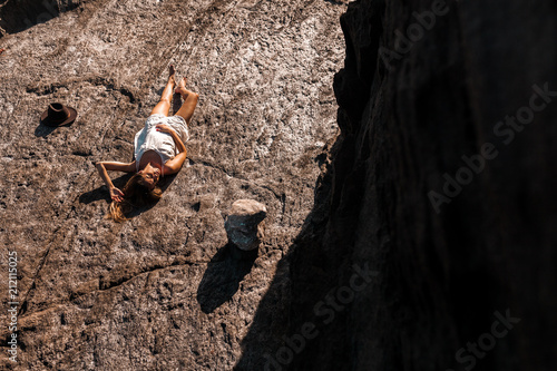 Relaxed woman lying on solid rock