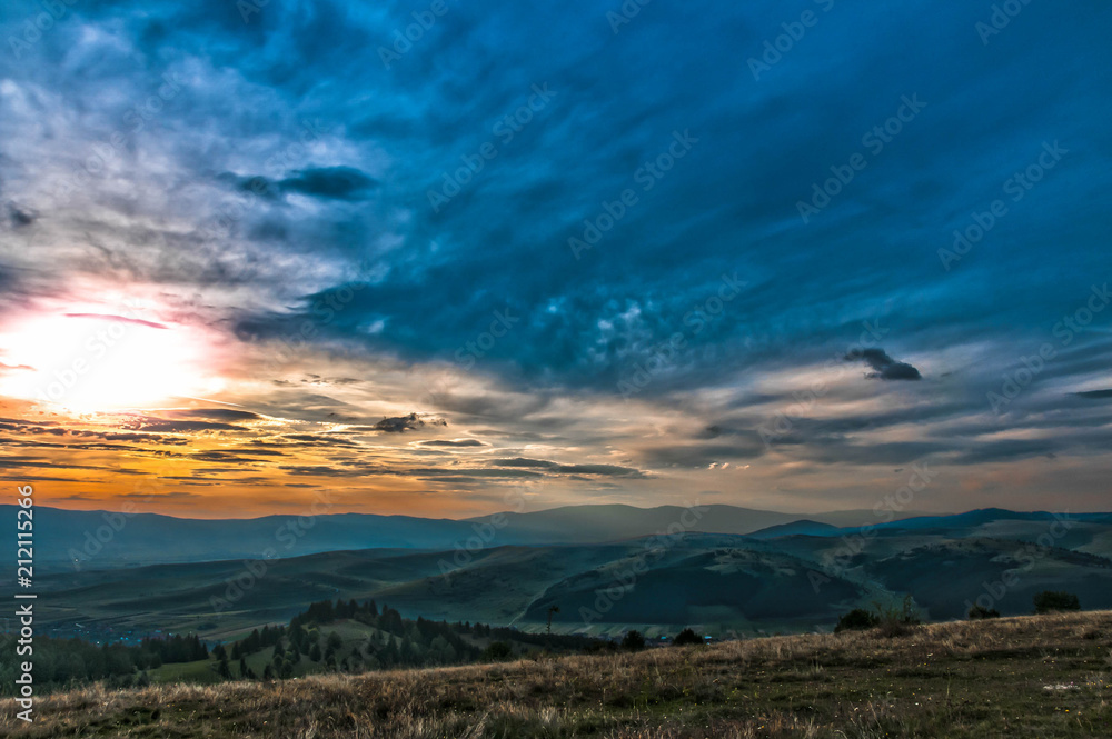 Scenic sunset view from the top of mountain ,Carpathian mountains in Transylvania, Romania.