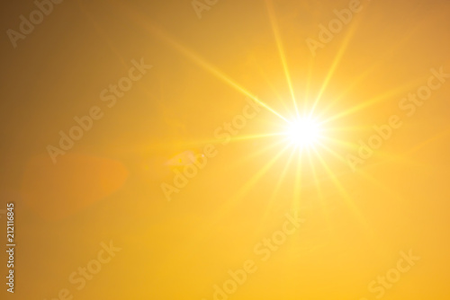 Hot summer or heat wave background, orange sky with glowing sun photo