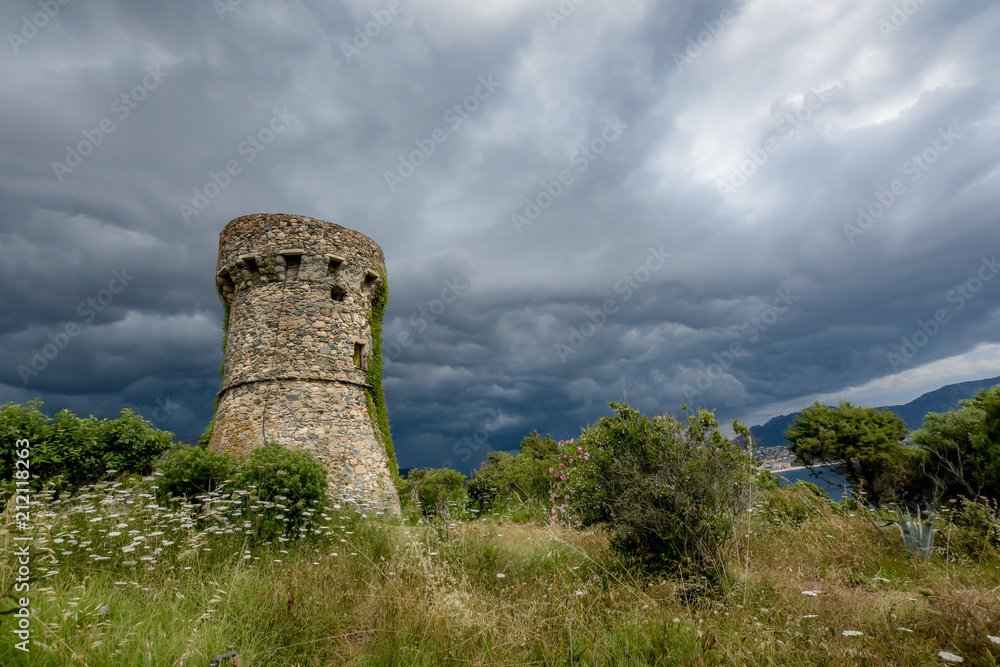 A stone tower in the dark weather. A stone tower in the dark weather.