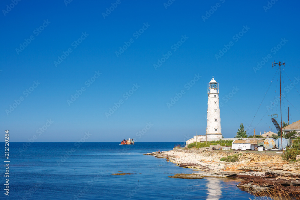 the lighthouse stands on the blue sea