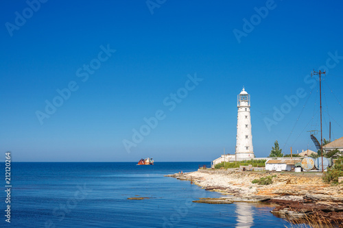 the lighthouse stands on the blue sea