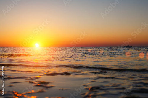 beautiful sunset over the sea the sun goes over the horizon © Екатерина Переславце