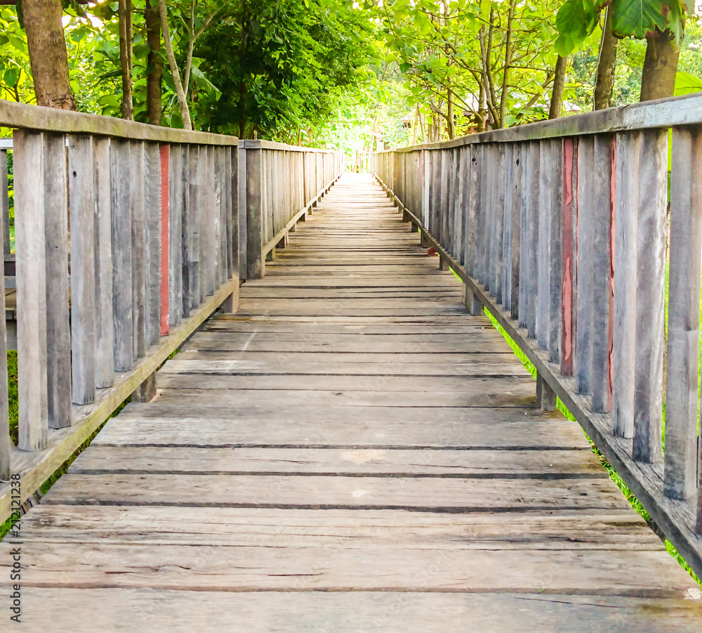 Wooden walk way bridge and sunlight in the beautiful garden