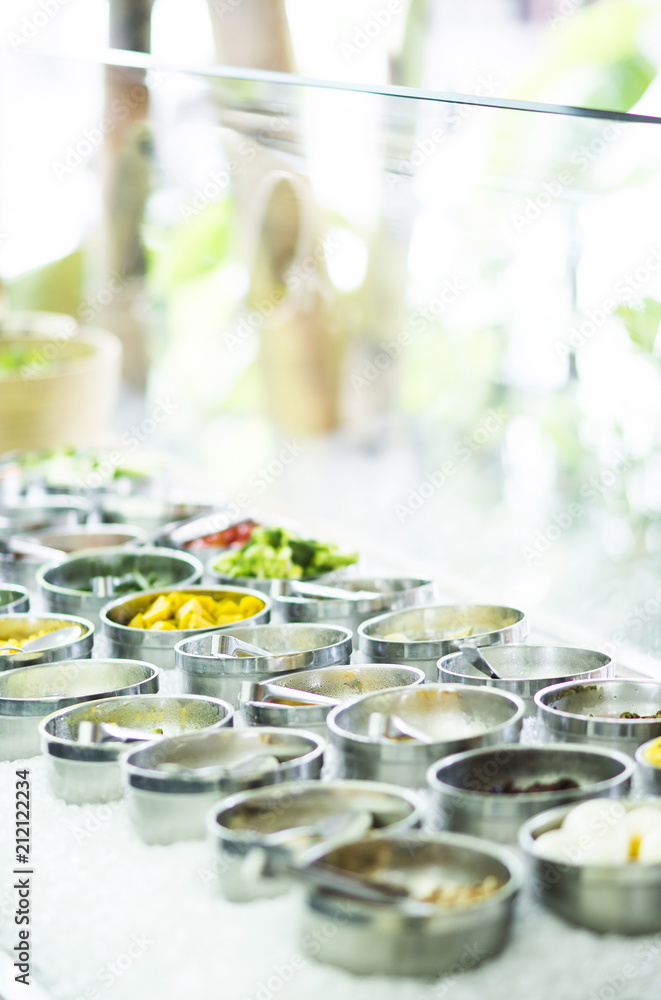 bowls of mixed fresh organic vegetables in salad bar display bowls of mixed fresh organic vegetables in salad bar display