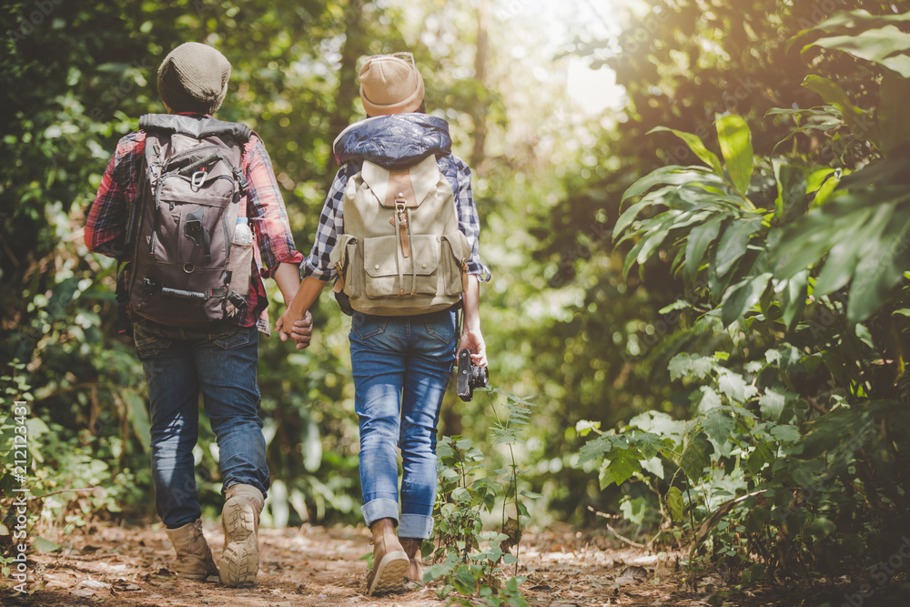 Lovers young hiking in the forest, Travel relax, Holiday and vacation, Love and relations, Travel hiking, Hiking concept.