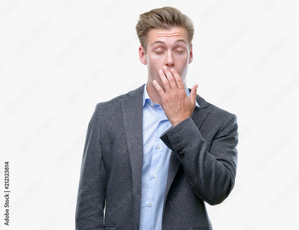 Young handsome blond business man bored yawning tired covering mouth with hand. Restless and sleepiness. Young handsome blond business man bored yawning tired covering mouth with hand. Restless and sleepiness.