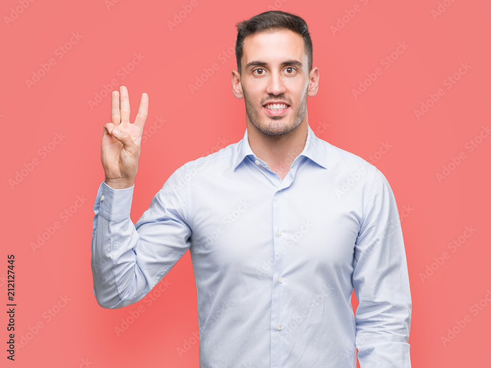 Handsome young businessman showing and pointing up with fingers number three while smiling confident and happy. Handsome young businessman showing and pointing up with fingers number three while smiling confident and happy.
