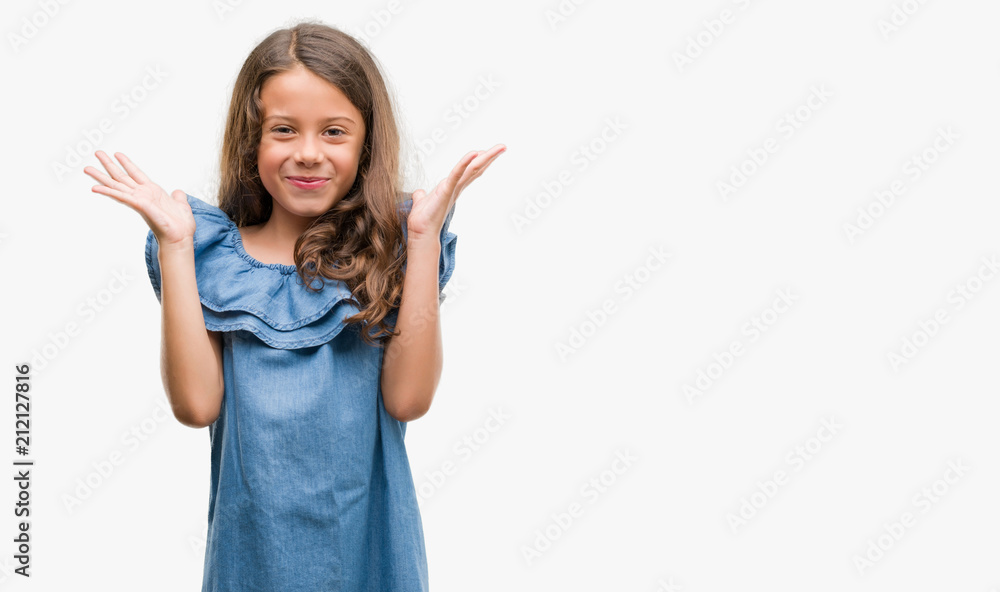 Brunette hispanic girl wearing denim dress very happy and excited, winner expression celebrating victory screaming with big smile and raised hands Brunette hispanic girl wearing denim dress very happy and excited, winner expression celebrating victory screaming with big smile and raised hands
