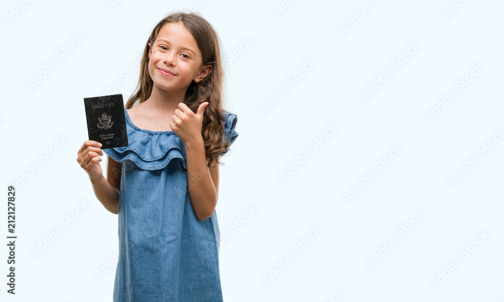 Brunette hispanic girl holding passport of United States of America happy with big smile doing ok sign, thumb up with fingers, excellent sign Brunette hispanic girl holding passport of United States of America happy with big smile doing ok sign, thumb up with fingers, excellent sign