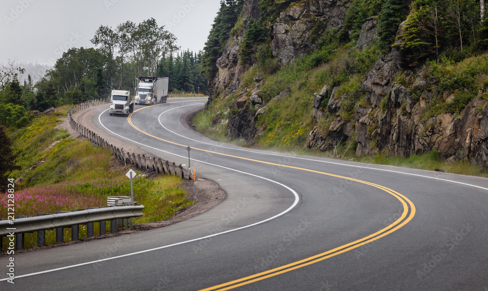 Winding highway with trucks north of Lake Superior. Winding highway with trucks north of Lake Superior.