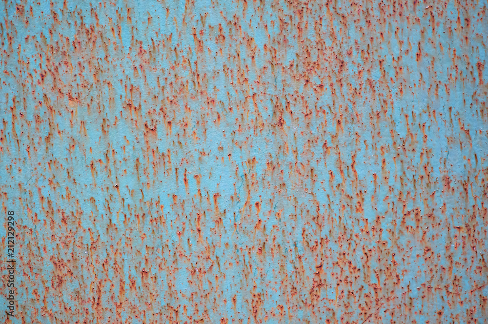 An old painted sheet of iron covered with rust. Abstract background. An old painted sheet of iron covered with rust. Abstract background.