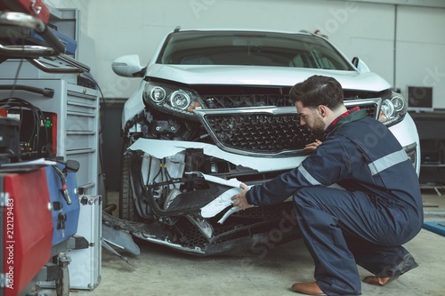 Mechanic repairing car in garage