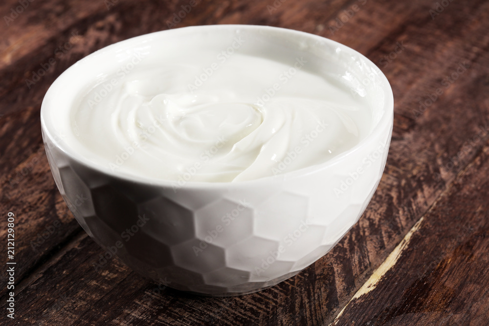 close up of a white whipped or sour cream in bowl. close up of a white whipped or sour cream in bowl.