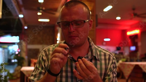 A man eating a fried scorpion in a Thai restaurant