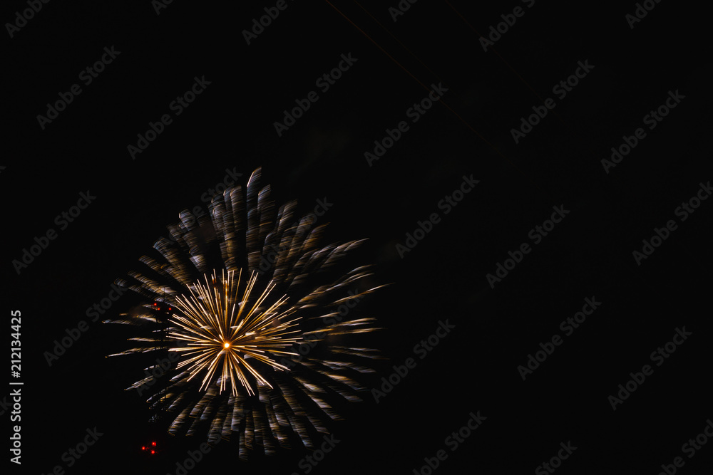 A beautiful bright colorful salute in the night sky of a big city due to a holiday A beautiful bright colorful salute in the night sky of a big city due to a holiday