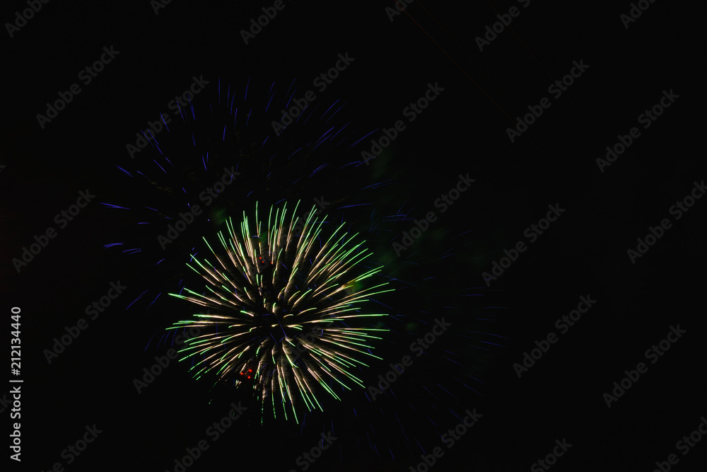 A beautiful bright colorful salute in the night sky of a big city due to a holiday A beautiful bright colorful salute in the night sky of a big city due to a holiday