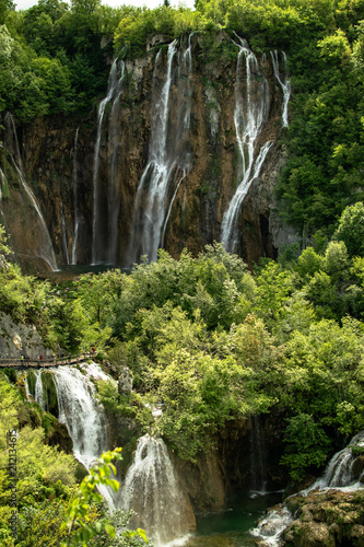 Set of waterfalls and lakes in a vertical shot to get to the idea of the magnitude of the precipice. Photograph taken in the plitvice lakes natural park in croatia.