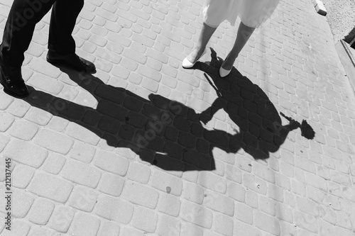 shadow of kissing newlyweds. wedding couple reflection. kissing wedding couple. kiss in the shade. bride is kissing groom bw. black and white.