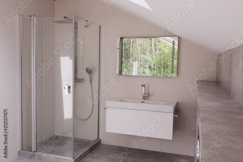 bathroom with transparent shower and washbasin