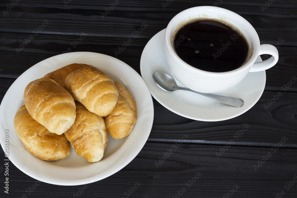 fresh croissants with black coffee with foam fresh croissants with black coffee with foam