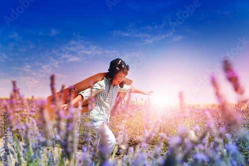 Boy pilot running through the lavender meadow