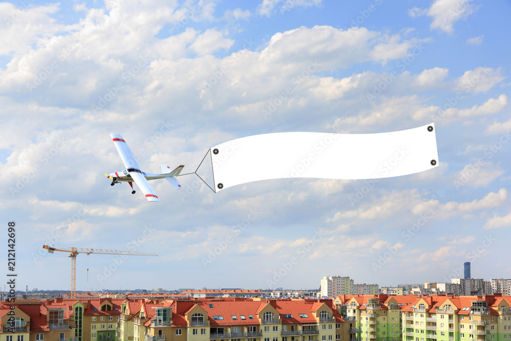 Reklama lotnicza, model samolot zdalnie sterowany z bilbordem reklamowym nad miastem Wrocław. - obrazy, fototapety, plakaty 
