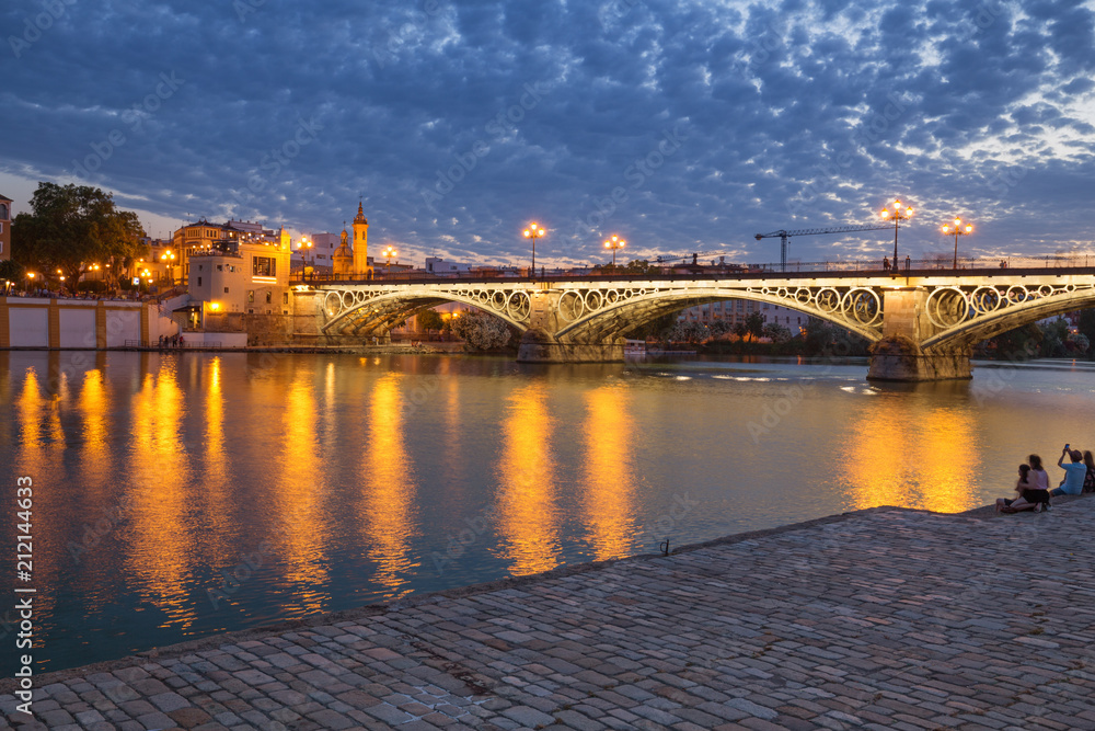 Seville, Spain, Night view of the bridge and fashionable and historic districts of Triana