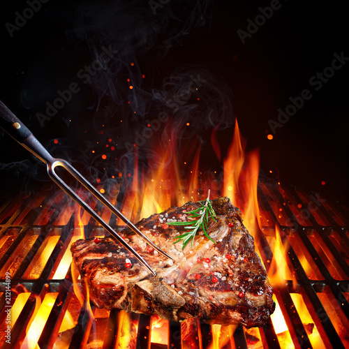 T-Bone Steak - Porterhouse  On Grill With Rosemary And Pink Pepper