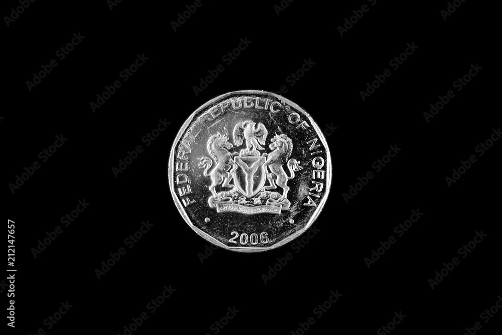 A close up image of a Nigerian bimettalic 50 kobo coin isolated on a black background A close up image of a Nigerian bimettalic 50 kobo coin isolated on a black background
