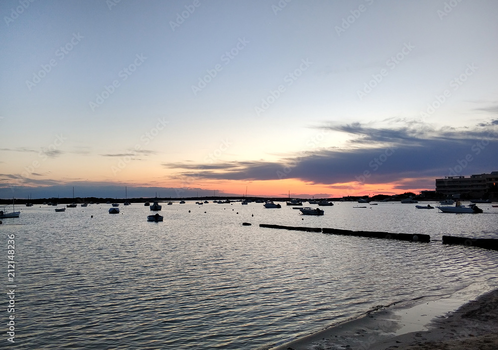 Mediterranean Sea and moored vessels at sunset. Formentera.  Spain