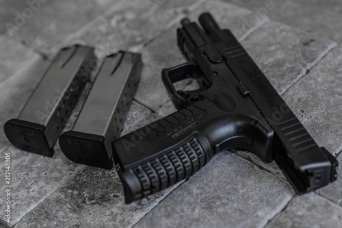 Handgun and High Capacity Magazines on Stone Tile