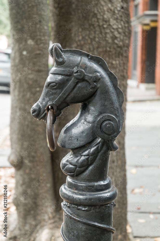 Cast iron hitching post in the form of a horse's head on the street in Savannah, Georgia, USA.