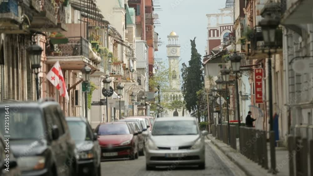 Car driving on Batumi street, traditional architecture, European city, tourism Car driving on Batumi street, traditional architecture, European city, tourism
